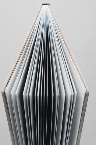 Top view of a hardcover photo book showing its thick, professionally bound inner pages.