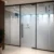 Frosted glass office partition with geometric pattern and Pinnacle Consulting Dubai logo.