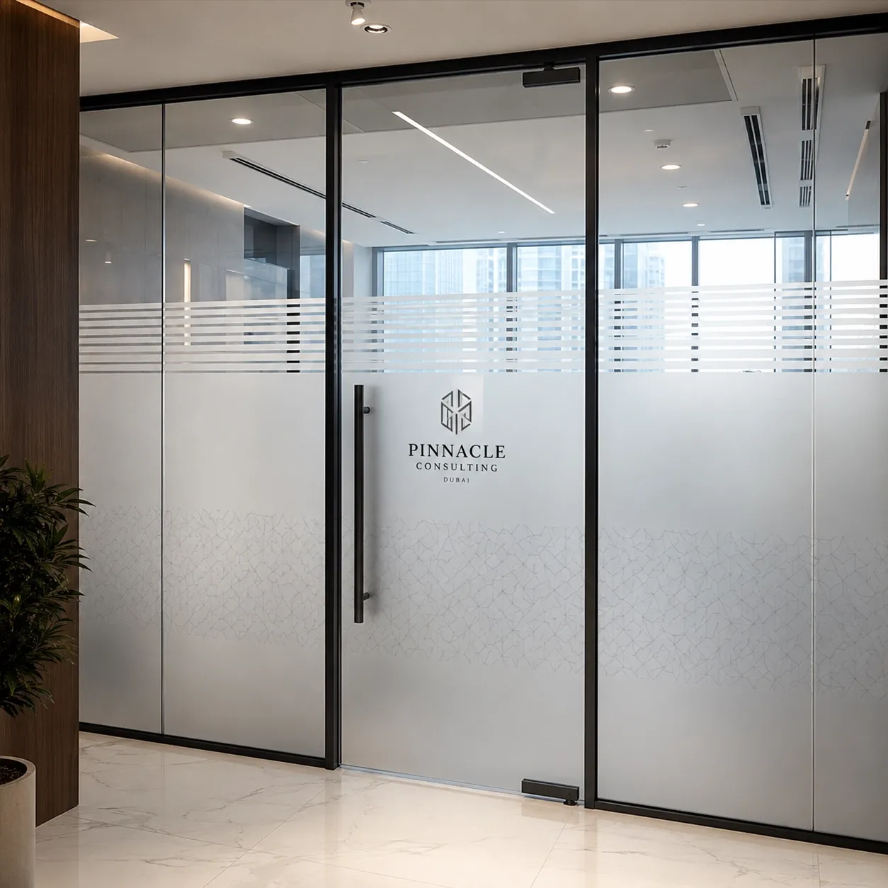frosted-glass-logo Frosted glass office partition with geometric pattern and Pinnacle Consulting Dubai logo.