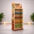 Left-angle view of a freestanding custom POS display unit with printed side graphics, branded header and colour-coded shelves.