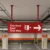 Double-sided hanging wayfinding signage in Dubai for parking area fire hose reel direction sign