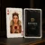 Custom Queen of Hearts playing card beside a personalised black and gold poker card back with company logo.