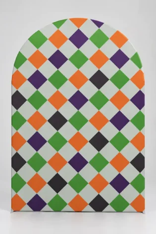 Halloween arch backdrop with an orange, green, purple, black and white harlequin diamond pattern
