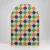 Halloween arch backdrop with an orange, green, purple, black and white harlequin diamond pattern